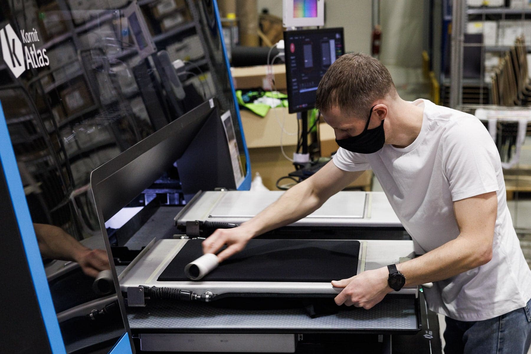 Premium cotton t-shirt loaded into a direct-to-garment printer before a Kosher Couture print-on-demand run